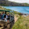 A family on tour od Dunedin's coastline in New Zealand