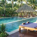 Unwind at an adults only swim-up pool bar amongst lush gardens at the Outrigger Fiji Beach Resort.