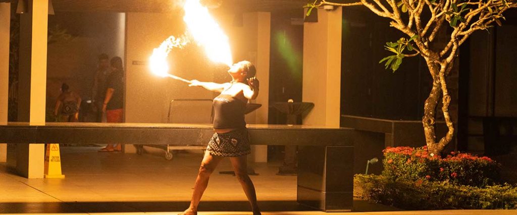A woman blowing fire as a part of Fijian fire-dancing.