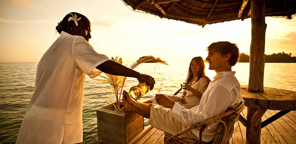 Enjoying a glass of white wine on a your villa's deck in Solomon Islands.