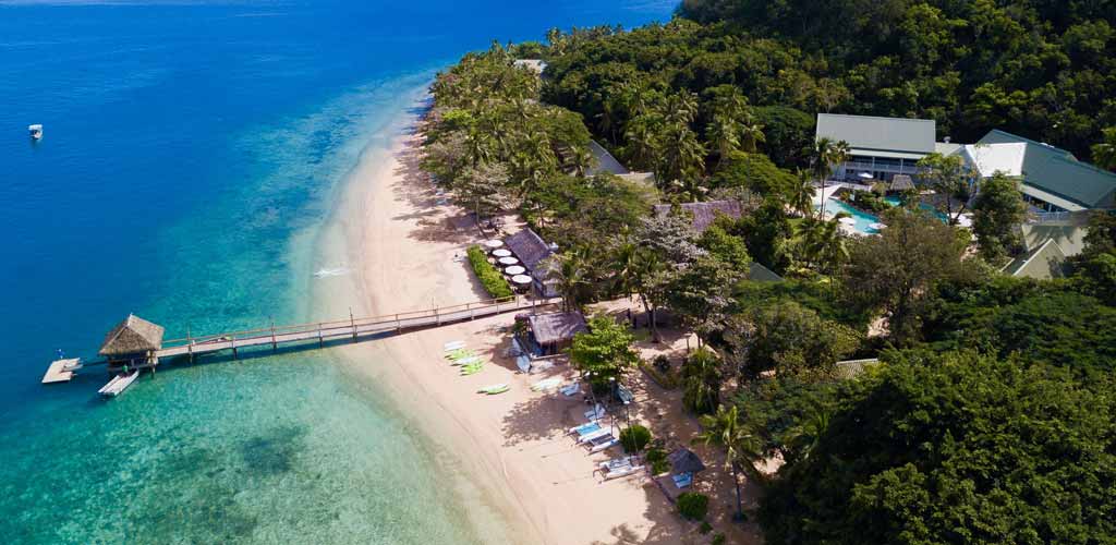 Drone view of the jetty and the bay at Malolo Island Resort in Fiji.