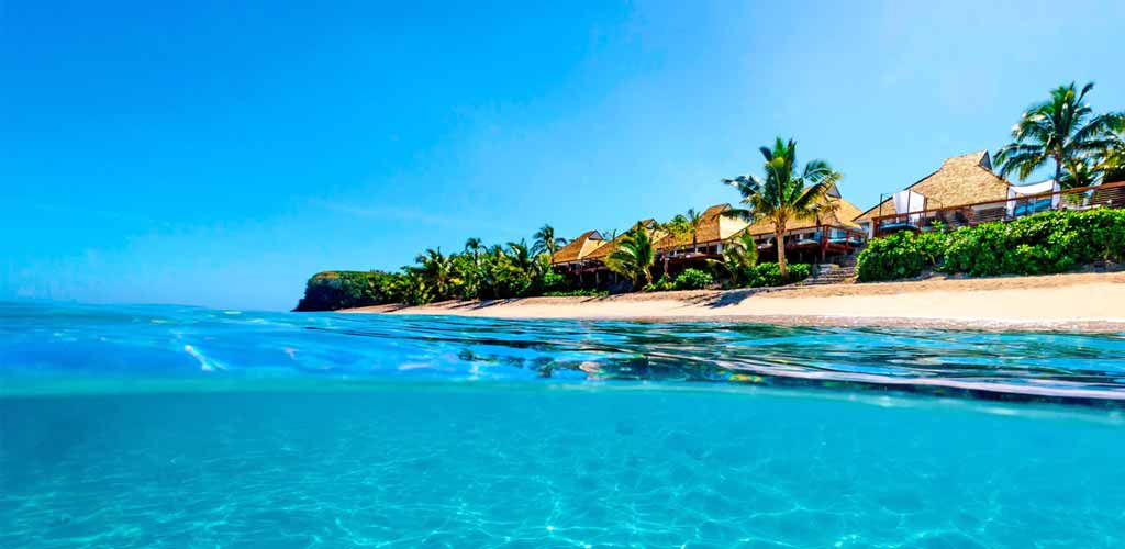 The clear waters and the beach at Sheraton Resort & Spa Tokoriki Island