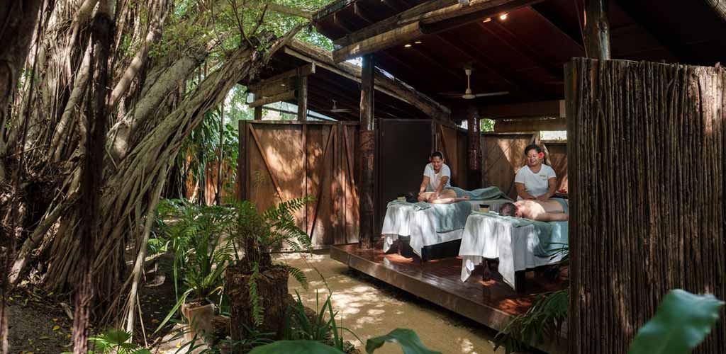 A couple enjoying a traditional Fijian spa session