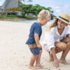 A woman playing with her child on a beach in Fiji