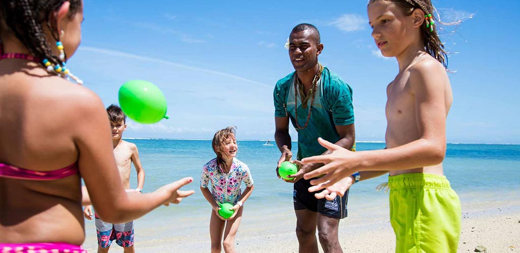 An activity coordinator playing with a group of kids at the Outrigger Fiji.