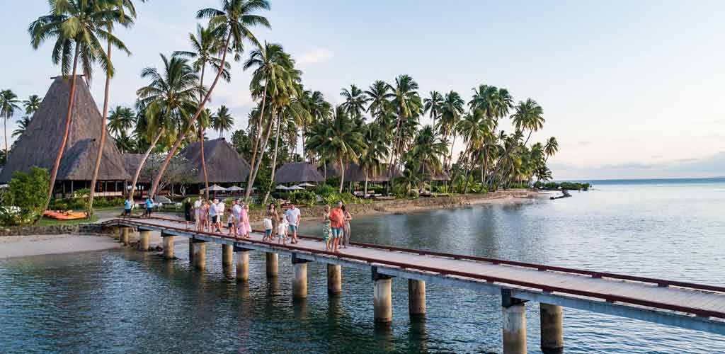 The island's jetty and the nakamal - main bure - of the Jean-Michel Cousteau Resort.