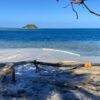 A view of the beach at Malolo Island Resort, the blue seas beyond at an island in the distance.